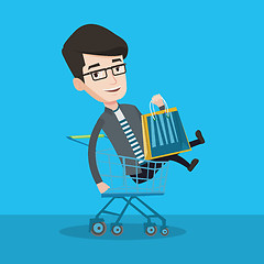 Image showing Happy man riding by shopping trolley.