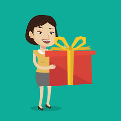 Image showing Joyful caucasian woman holding box with gift.