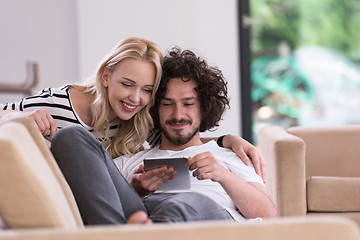 Image showing couple relaxing at  home with tablet computers