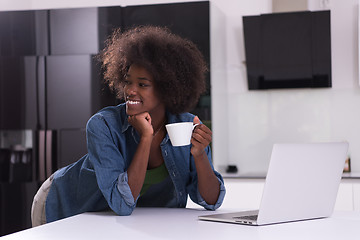 Image showing smiling black woman in modern kitchen