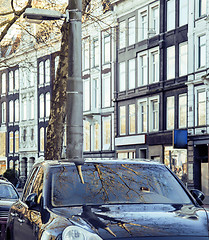 Image showing european parking, cars on background with Amsterdam facade sunny day