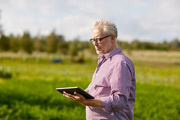 Image showing senior man with tablet pc computer at county