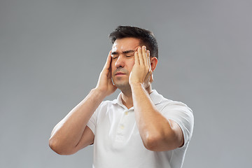 Image showing unhappy man suffering from head ache