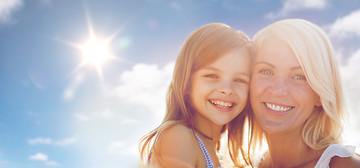 Image showing happy mother and child girl over sun in blue sky