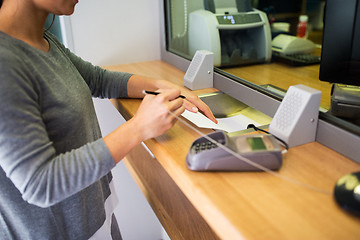 Image showing customer writing application at bank office