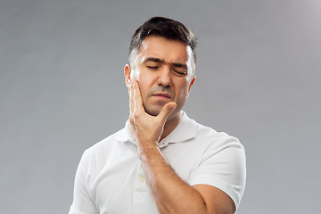 Image showing unhappy man suffering toothache