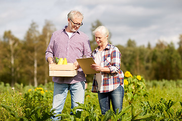 Image showing senior couple with box of vegetables at farm