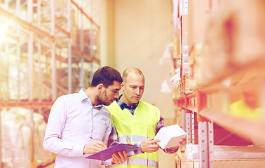 Image showing worker and businessmen with clipboard at warehouse