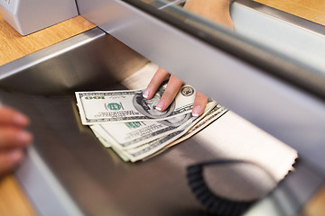 Image showing clerk giving cash money to customer at bank office