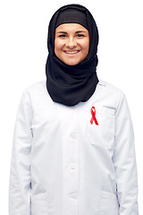 Image showing muslim doctor in hijab with red awareness ribbon