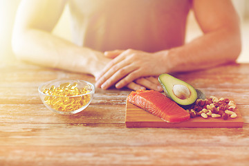 Image showing close up of male hands with food rich in protein