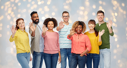 Image showing international group of happy people waving hand