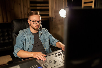 Image showing man at mixing console in music recording studio