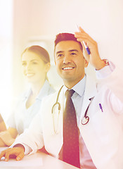 Image showing group of happy doctors on conference at hospital