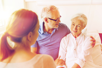 Image showing happy family visiting senior woman at hospital