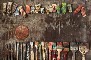 Image showing paint brushes and tubes of oil paints on wooden background