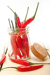 Image showing red chili peppers on a glass jar