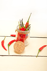 Image showing red chili peppers on a glass jar