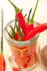 Image showing red chili peppers on a glass jar