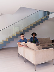 Image showing young multiethnic couple relaxes in the living room