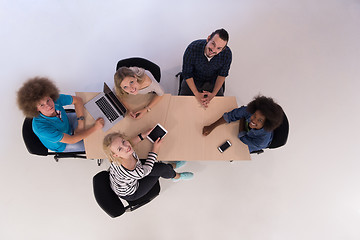 Image showing Multiethnic startup business team on meeting  top view