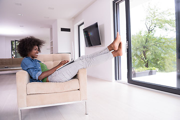 Image showing African American women at home in the chair using a laptop