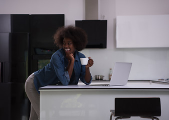 Image showing smiling black woman in modern kitchen