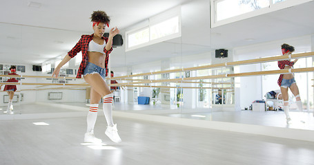 Image showing Female dancing student takes steps in studio