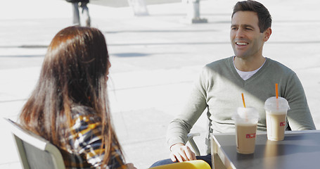 Image showing Young couple enjoying takeaway coffee