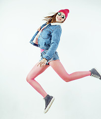 Image showing lifestyle people concept: happy smiling hipster girl jumping on white background isolated