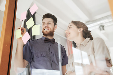 Image showing creative team with stickers on glass at office