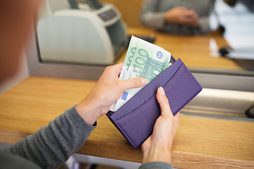 Image showing hands with money at bank or currency exchanger