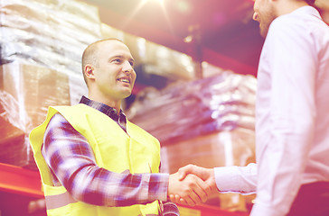 Image showing worker and businessmen with clipboard at warehouse