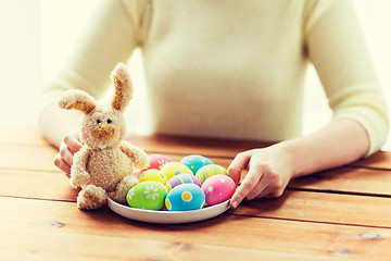 Image showing close up of woman hands with easter eggs and bunny