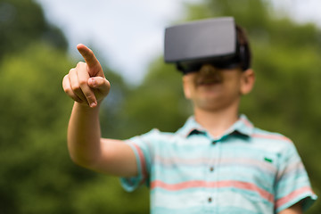 Image showing boy with virtual reality headset outdoors