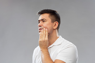 Image showing unhappy man suffering toothache