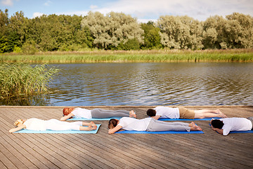 Image showing group of people making yoga exercises outdoors