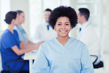 Image showing happy doctor over group of medics at hospital