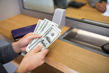 Image showing hands with money at bank or currency exchanger
