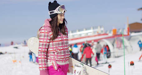 Image showing Cute and happy female asian snowboarder