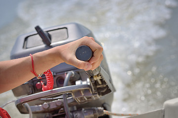 Image showing Fisherman hand and boat engine