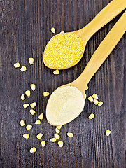 Image showing Flour and cereals corn in spoon on dark board top