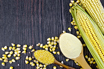 Image showing Flour and grits corn in spoons on dark wooden board