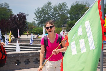 Image showing Cheerful woman holding flag