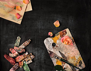 Image showing paint brushes and tubes of oil paints on wooden background