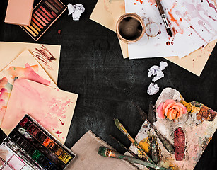 Image showing paint brushes and tubes of oil paints on wooden background