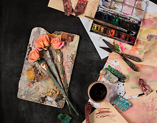 Image showing paint brushes and tubes of oil paints on wooden background