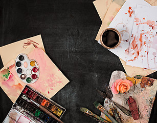 Image showing paint brushes and tubes of oil paints on wooden background