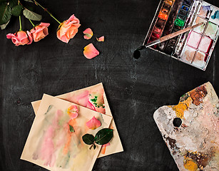 Image showing paint brushes and tubes of oil paints on wooden background