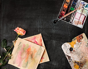 Image showing paint brushes and tubes of oil paints on wooden background